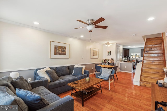 living room with light wood finished floors, stairway, recessed lighting, and crown molding