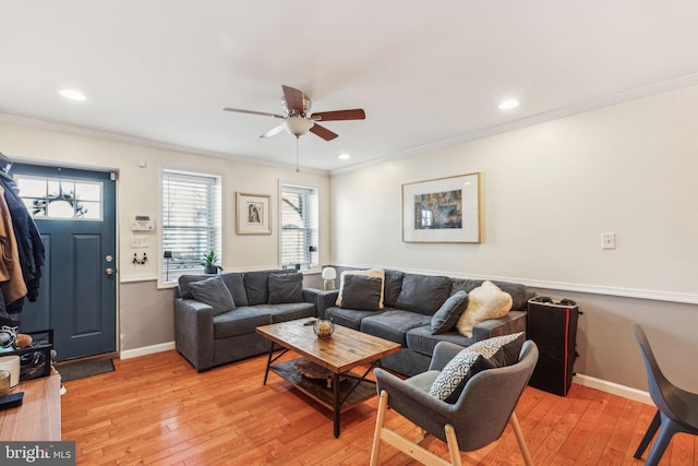 living room featuring recessed lighting, baseboards, light wood-style floors, and crown molding