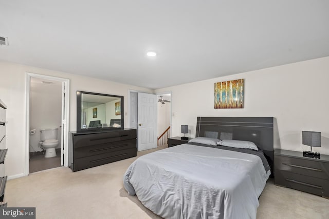 bedroom with visible vents, carpet floors, and connected bathroom