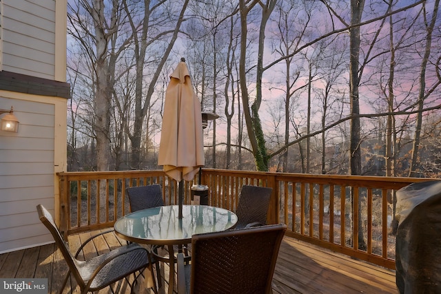 deck featuring outdoor dining space and a grill