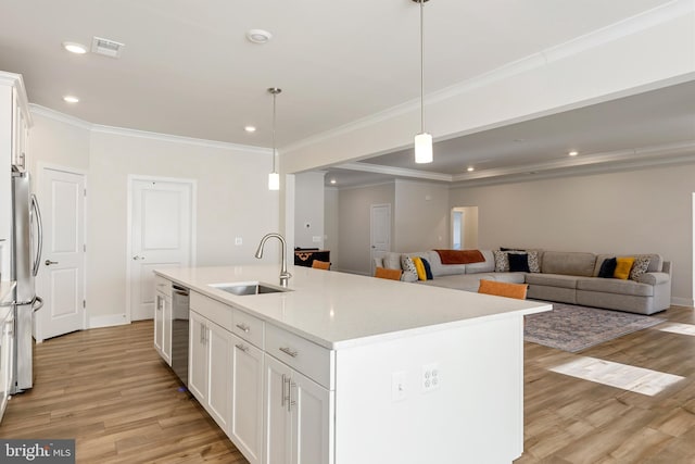 kitchen featuring light wood finished floors, white cabinetry, stainless steel appliances, and a sink