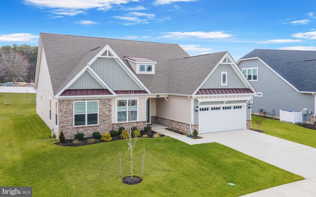 craftsman-style house featuring driveway, a front yard, a standing seam roof, and metal roof