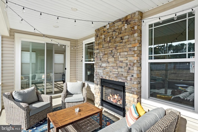 view of patio / terrace with an outdoor living space with a fireplace