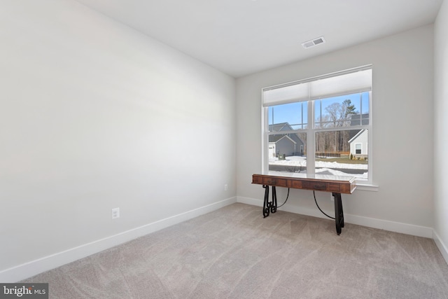 carpeted office with visible vents and baseboards