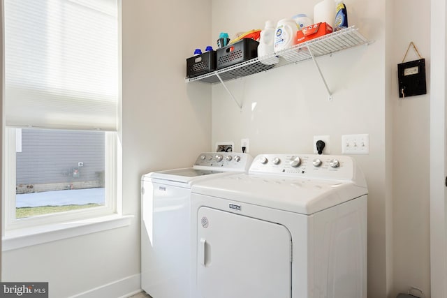 laundry area with washing machine and clothes dryer and laundry area