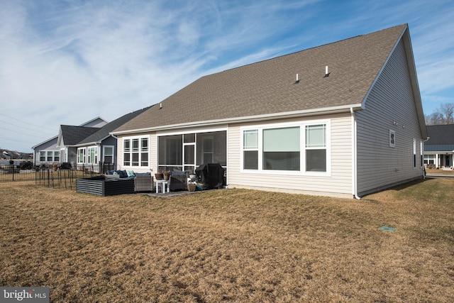 back of property with outdoor lounge area, a yard, fence, and roof with shingles