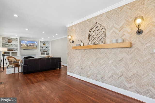 living area with a fireplace, crown molding, baseboards, and dark wood-style flooring