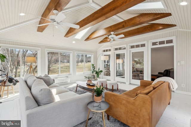 sunroom featuring vaulted ceiling with skylight and ceiling fan