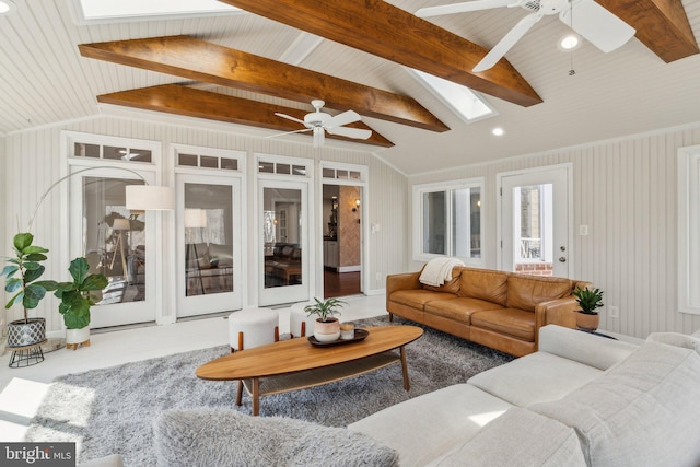 living room featuring vaulted ceiling with skylight and ceiling fan