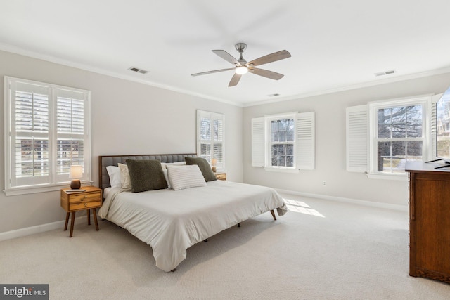 bedroom with visible vents, light carpet, and crown molding