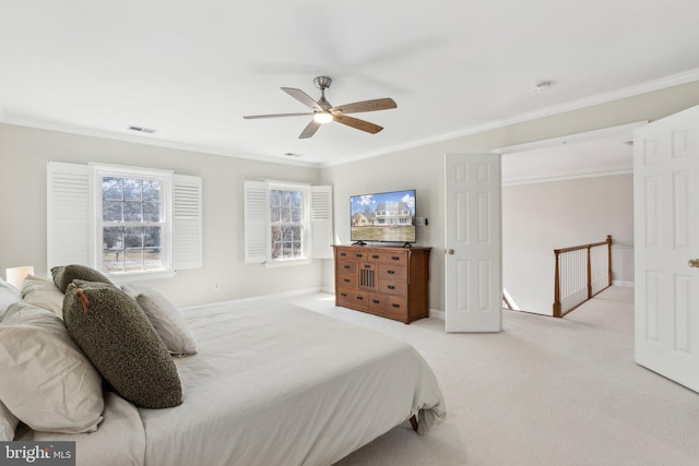 bedroom featuring crown molding, baseboards, visible vents, and light carpet