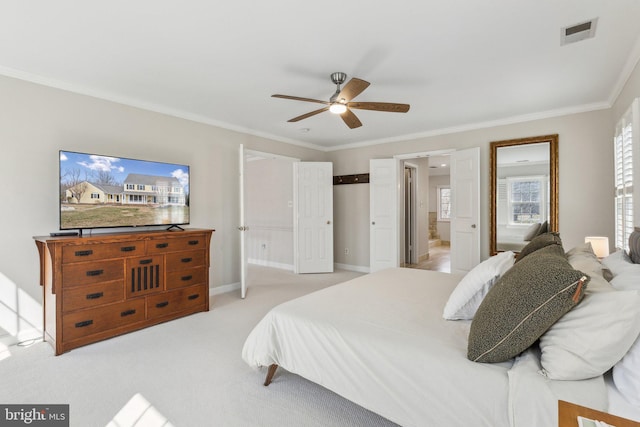 bedroom with visible vents, baseboards, ensuite bathroom, crown molding, and light colored carpet