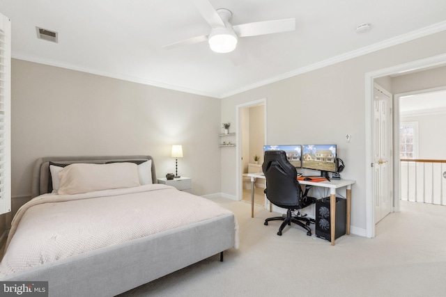 bedroom with visible vents, light colored carpet, baseboards, and ornamental molding