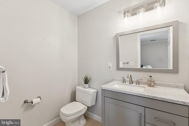 bathroom featuring baseboards, toilet, vanity, and tile patterned flooring