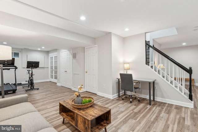 living room with recessed lighting, baseboards, wood finished floors, and stairs