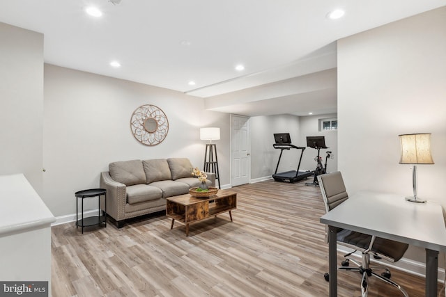 living room with recessed lighting, baseboards, and light wood-style floors