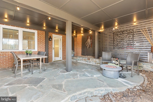 view of patio / terrace featuring outdoor dining space and a fire pit