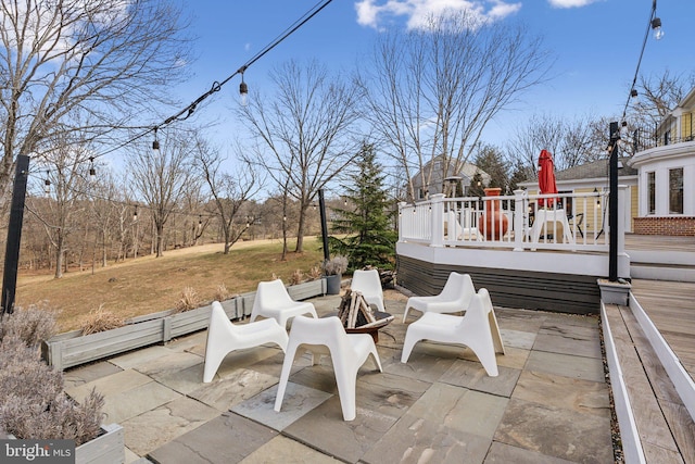 view of patio / terrace featuring a fire pit and a deck