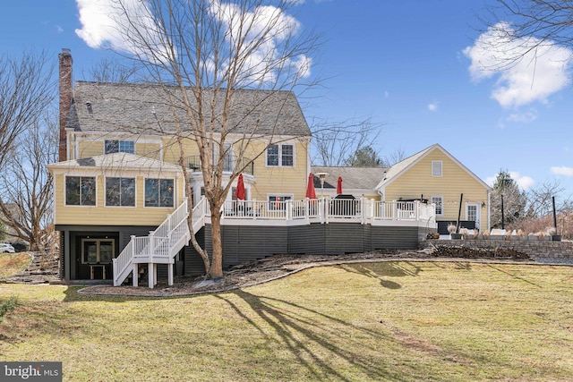 rear view of property with a lawn, a wooden deck, and stairs