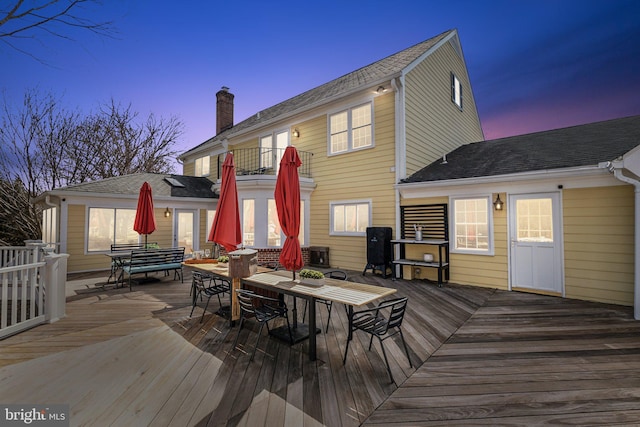 wooden terrace featuring outdoor dining area