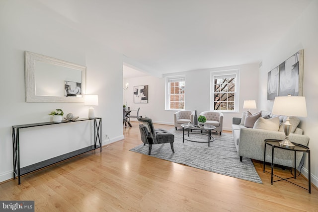 living room featuring baseboards and wood finished floors