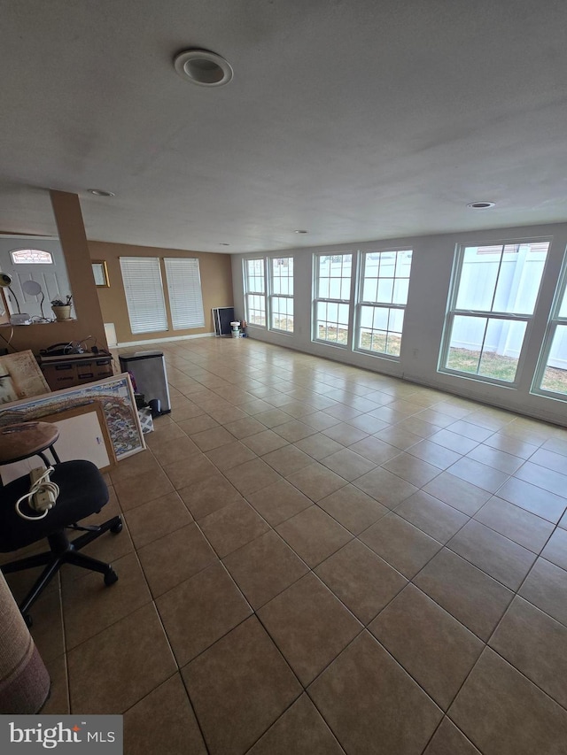 unfurnished living room featuring tile patterned flooring