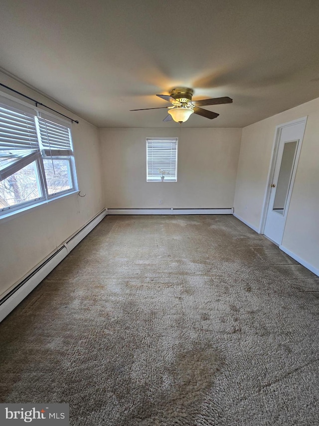 carpeted empty room featuring a baseboard heating unit, baseboards, and a ceiling fan