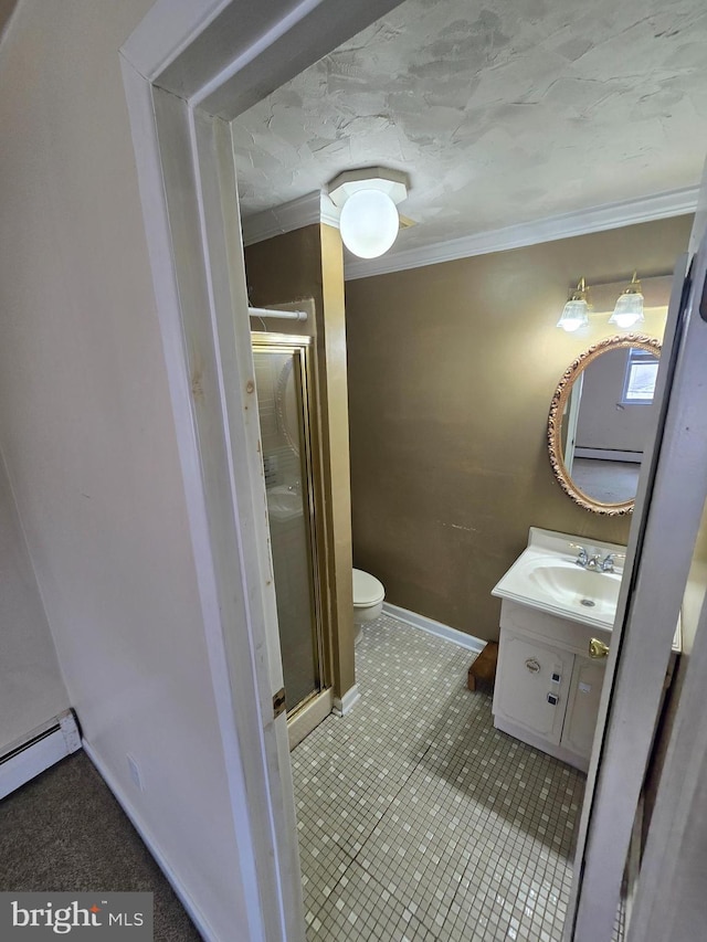 bathroom with toilet, a baseboard heating unit, a shower stall, crown molding, and vanity