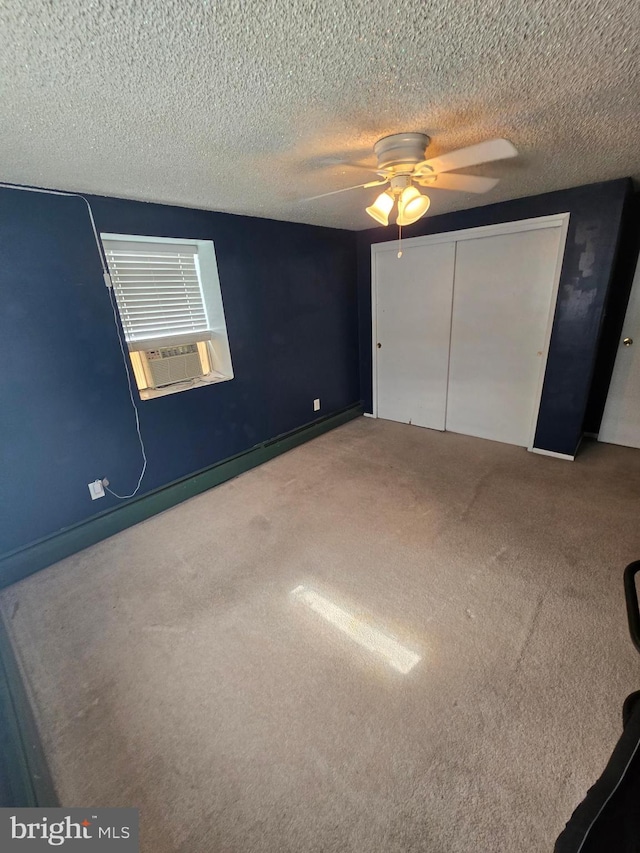 unfurnished bedroom with a closet, carpet floors, a textured ceiling, and ceiling fan