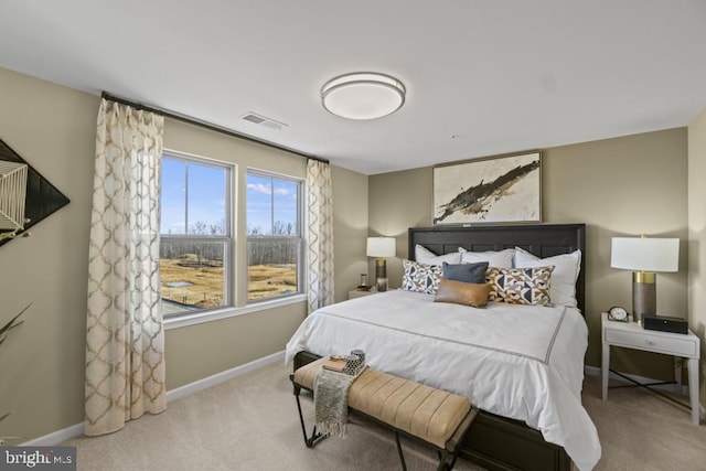 carpeted bedroom featuring visible vents and baseboards