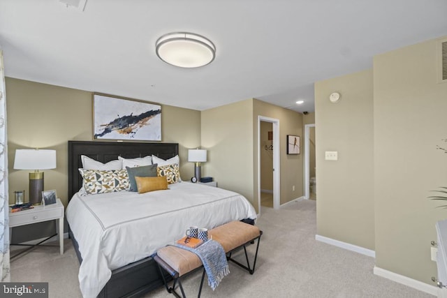 bedroom with baseboards and light carpet