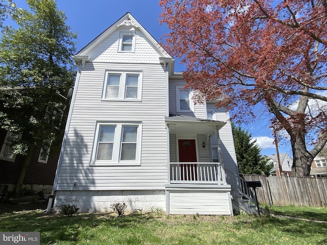 victorian home featuring fence
