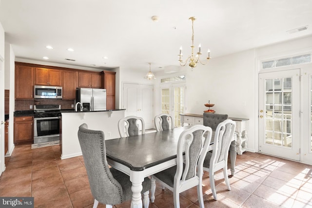 dining space with visible vents, an inviting chandelier, light tile patterned flooring, recessed lighting, and french doors