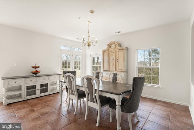 dining space featuring a notable chandelier, visible vents, baseboards, and a wealth of natural light