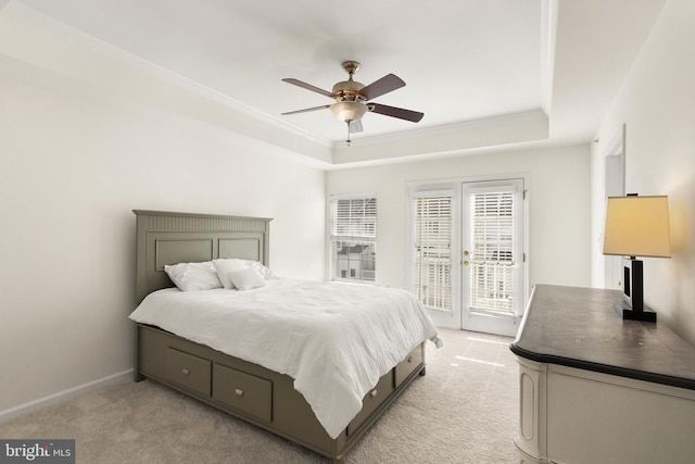 bedroom featuring a raised ceiling, light carpet, crown molding, and access to outside