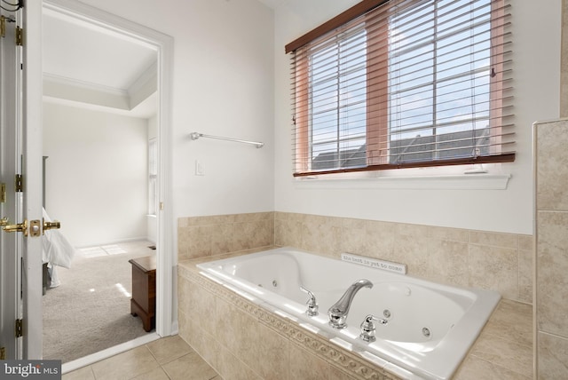 bathroom with tile patterned floors and a tub with jets