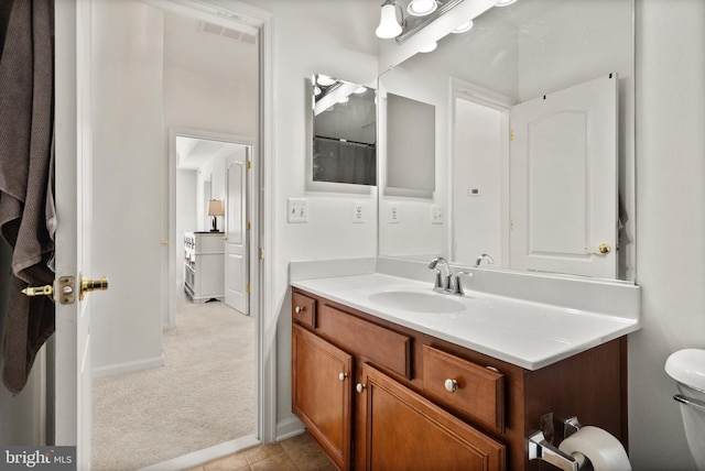 bathroom featuring tile patterned flooring, visible vents, baseboards, toilet, and vanity