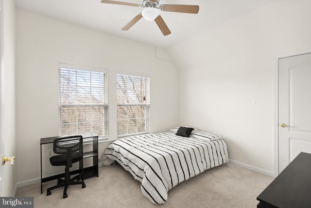 carpeted bedroom featuring lofted ceiling, baseboards, and ceiling fan