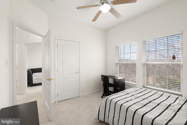 bedroom featuring ceiling fan, baseboards, and carpet