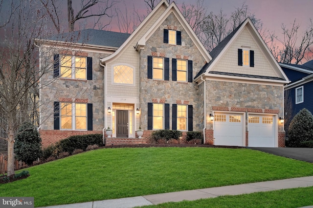 view of front facade with a garage, a lawn, stone siding, and driveway