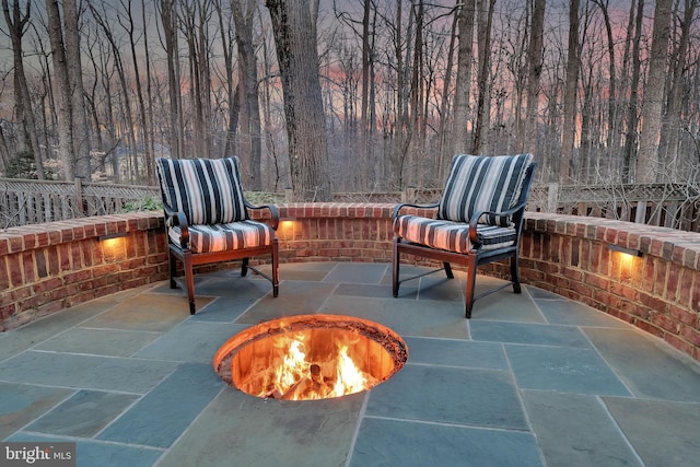 view of patio / terrace featuring a fire pit and fence