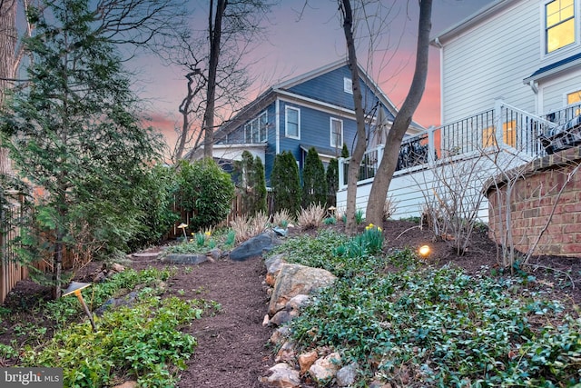 property exterior at dusk with fence