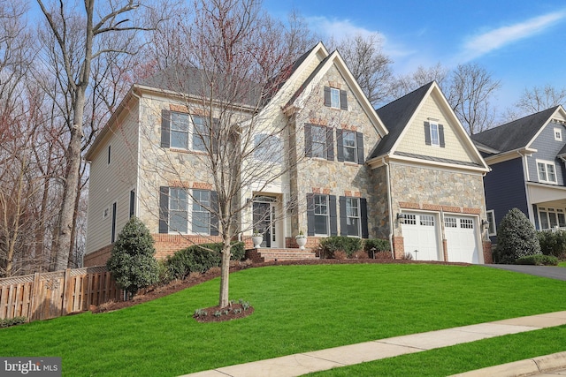 view of front of house with fence, a front yard, driveway, stone siding, and an attached garage