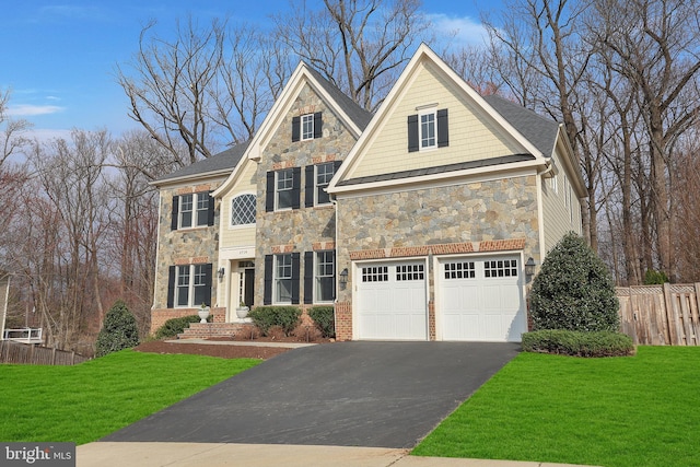 traditional-style home featuring stone siding, driveway, a garage, and fence