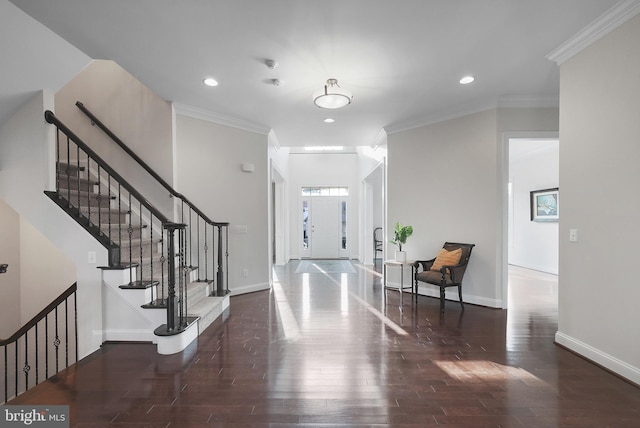 entryway featuring baseboards, wood finished floors, and ornamental molding