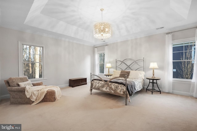 carpeted bedroom with visible vents, a raised ceiling, a notable chandelier, and baseboards