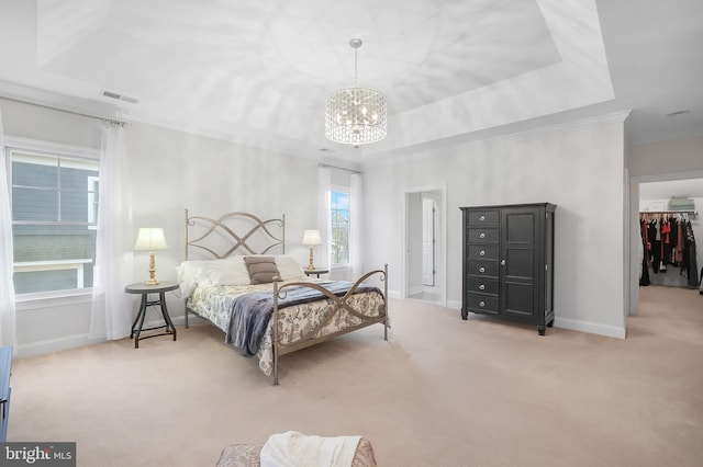 bedroom featuring a chandelier, carpet flooring, a raised ceiling, and visible vents