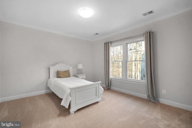 bedroom featuring baseboards, light colored carpet, visible vents, and ornamental molding