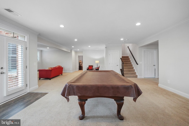 recreation room with visible vents, baseboards, crown molding, and carpet