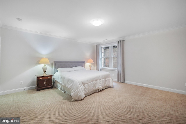 carpeted bedroom featuring crown molding and baseboards